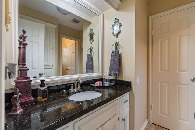 bathroom with vanity and visible vents
