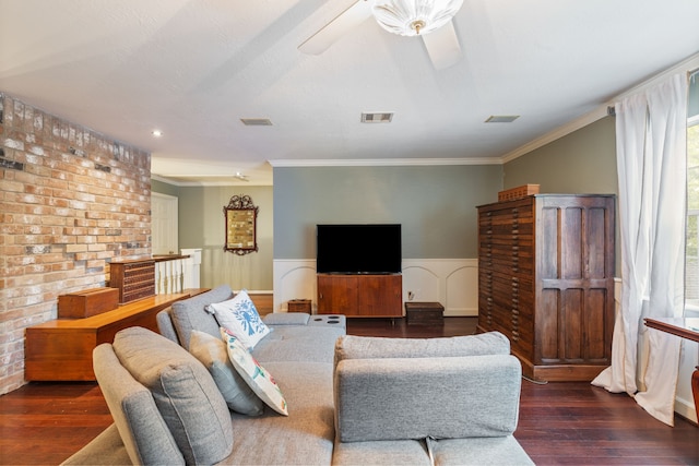 living room featuring a wainscoted wall, visible vents, wood finished floors, and ornamental molding