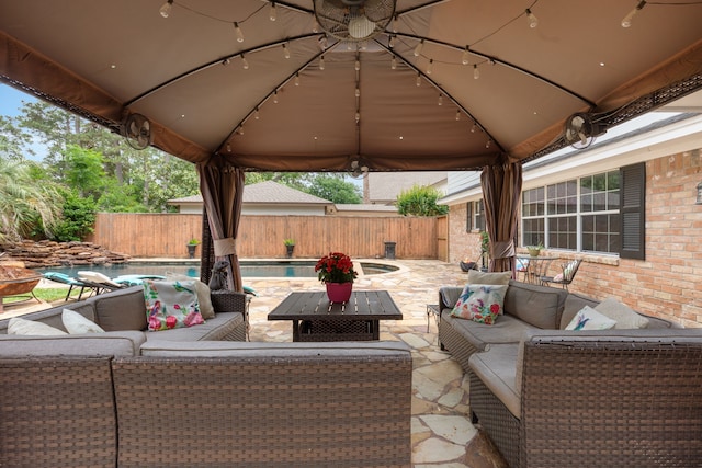 view of patio / terrace featuring a fenced backyard, a gazebo, an outdoor hangout area, and a fenced in pool