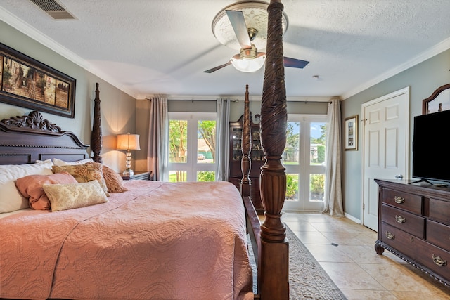 bedroom featuring multiple windows, a textured ceiling, visible vents, and access to exterior