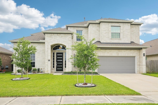 4814 Goldeneye Dr, Baytown, TX 77521 - french country home featuring an attached garage, a front lawn, driveway, and brick siding