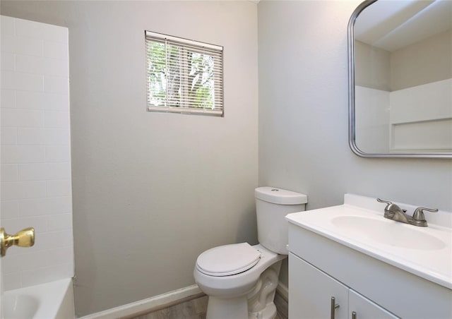 bathroom featuring toilet, bathtub / shower combination, wood finished floors, and vanity
