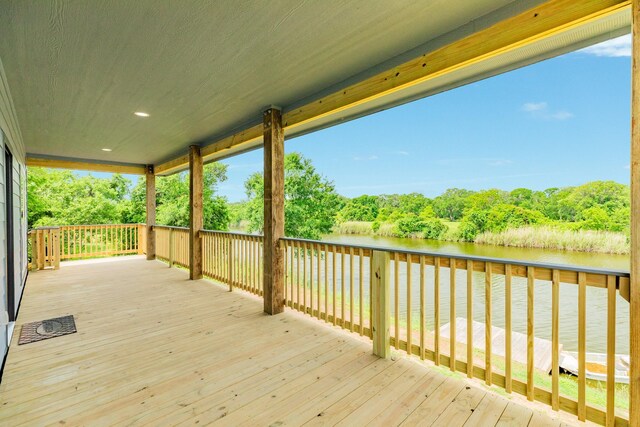 wooden terrace featuring a water view