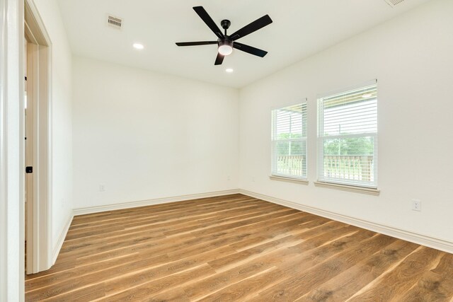 spare room with recessed lighting, baseboards, a ceiling fan, wood finished floors, and visible vents