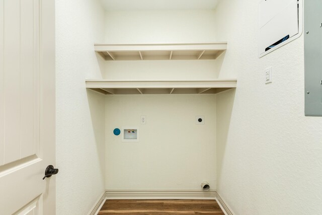 clothes washing area featuring laundry area, hookup for a washing machine, wood finished floors, and electric dryer hookup