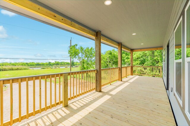wooden terrace with a water view