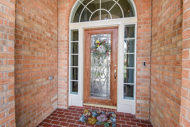entrance to property with brick siding