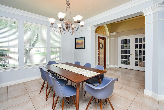 dining area with decorative columns, light tile patterned flooring, a notable chandelier, and a healthy amount of sunlight