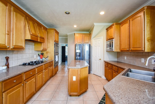 kitchen with a sink, a center island, stainless steel appliances, tasteful backsplash, and ornamental molding