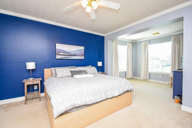 bedroom featuring ceiling fan, visible vents, crown molding, baseboards, and light carpet
