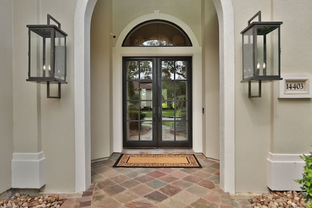 property entrance with french doors and stucco siding
