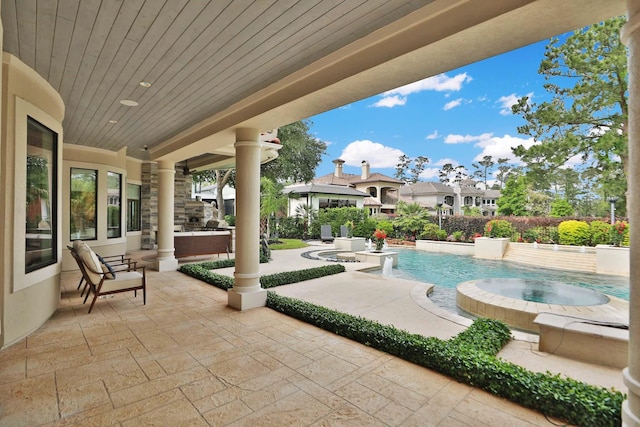 view of patio / terrace with an in ground hot tub and an outdoor pool
