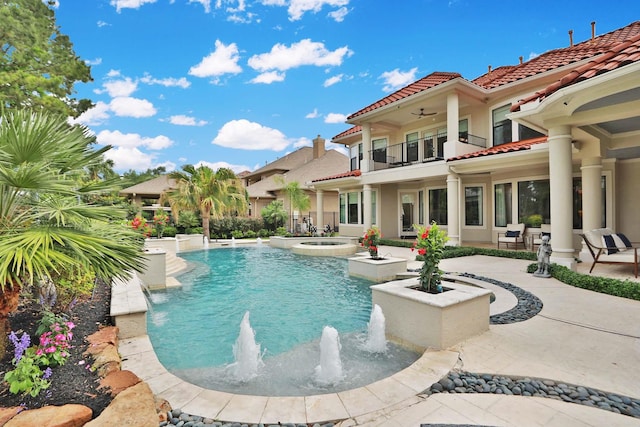 view of pool featuring a ceiling fan, a patio, and a pool with connected hot tub