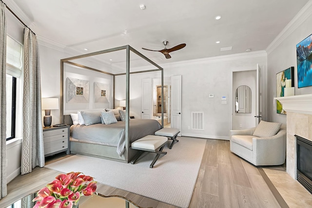 bedroom featuring visible vents, ornamental molding, wood finished floors, a fireplace, and recessed lighting