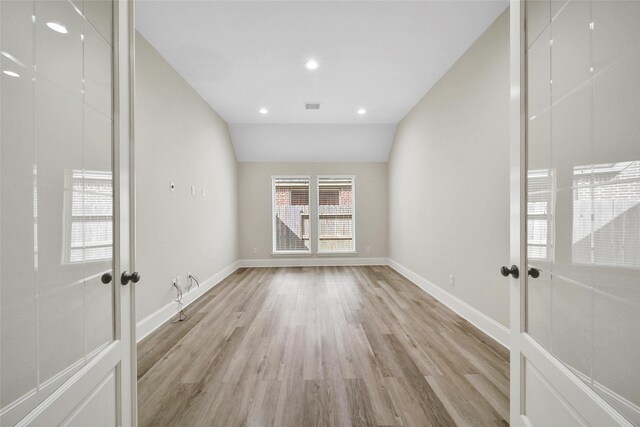 empty room with visible vents, baseboards, recessed lighting, french doors, and light wood-style flooring