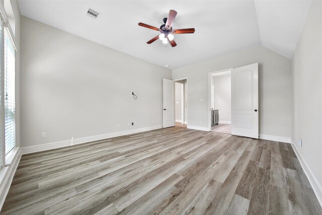 unfurnished bedroom with baseboards, visible vents, multiple windows, and light wood finished floors