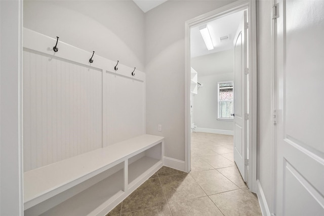 mudroom featuring baseboards, light tile patterned floors, and visible vents