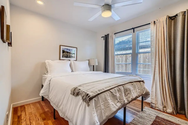 bedroom with baseboards, recessed lighting, light wood-style flooring, and ceiling fan