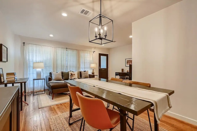dining space with visible vents, baseboards, a chandelier, light wood-style floors, and recessed lighting