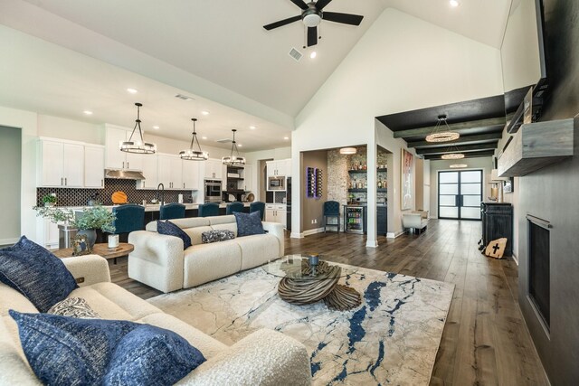 living room featuring ceiling fan, visible vents, high vaulted ceiling, dark wood-style floors, and recessed lighting
