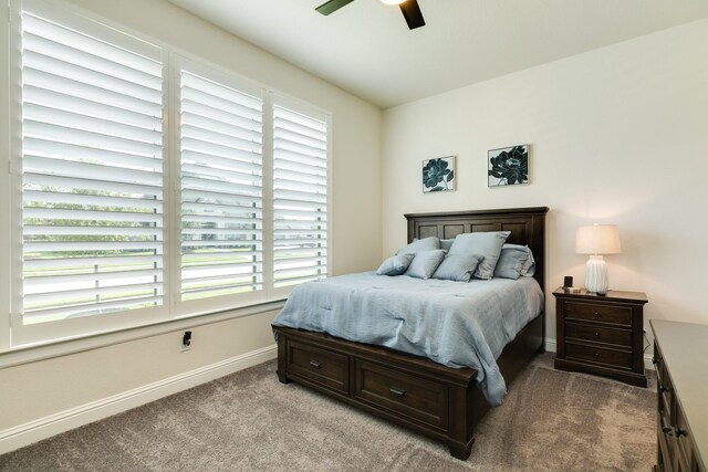 carpeted bedroom with baseboards and a ceiling fan