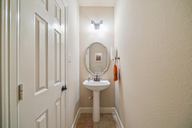 bathroom featuring baseboards and tile patterned flooring