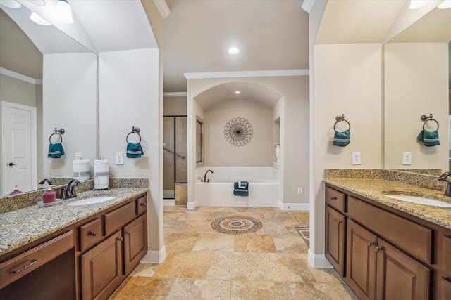 bathroom with stone tile flooring, a sink, crown molding, and a bath