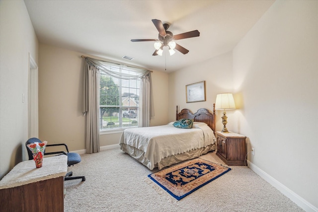 carpeted bedroom featuring baseboards, visible vents, and ceiling fan