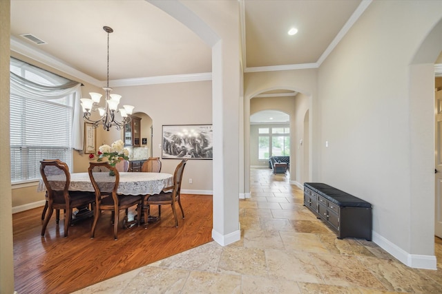 dining area featuring arched walkways and baseboards
