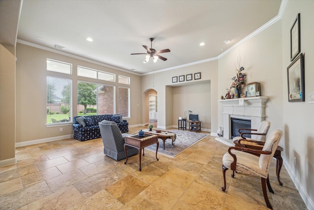 living room with ornamental molding, a ceiling fan, stone tile flooring, and visible vents