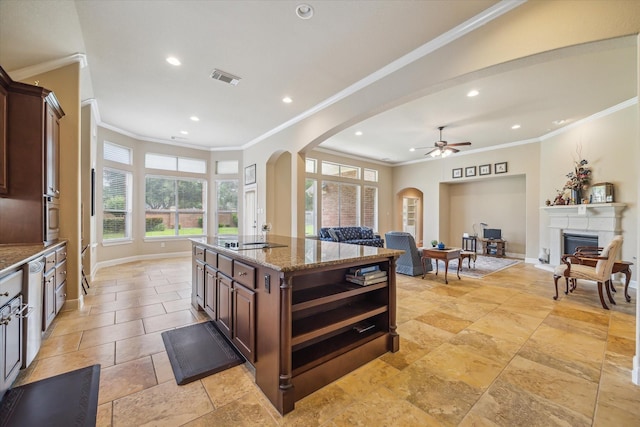 kitchen featuring visible vents, arched walkways, ceiling fan, and open floor plan