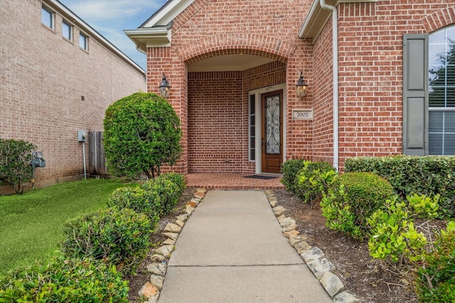 property entrance with brick siding