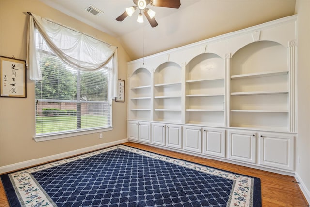 unfurnished room with light wood-type flooring, a ceiling fan, visible vents, and a wealth of natural light
