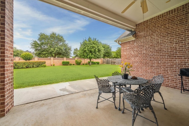 view of patio / terrace with ceiling fan, outdoor dining space, and a fenced backyard