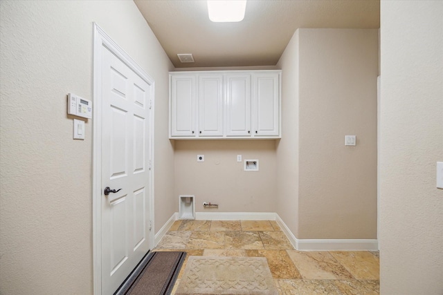 laundry area with gas dryer hookup, hookup for an electric dryer, washer hookup, cabinet space, and stone tile floors