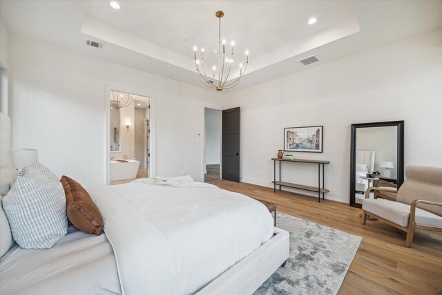 bedroom featuring visible vents, recessed lighting, a raised ceiling, and an inviting chandelier