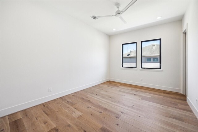 empty room featuring light wood-style flooring, a ceiling fan, baseboards, recessed lighting, and visible vents