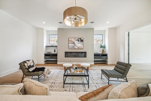 living room featuring light wood-style floors and visible vents