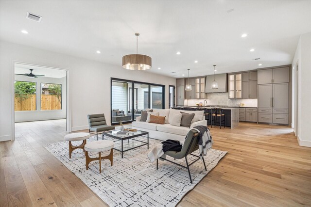 living area featuring recessed lighting, visible vents, and light wood-style flooring