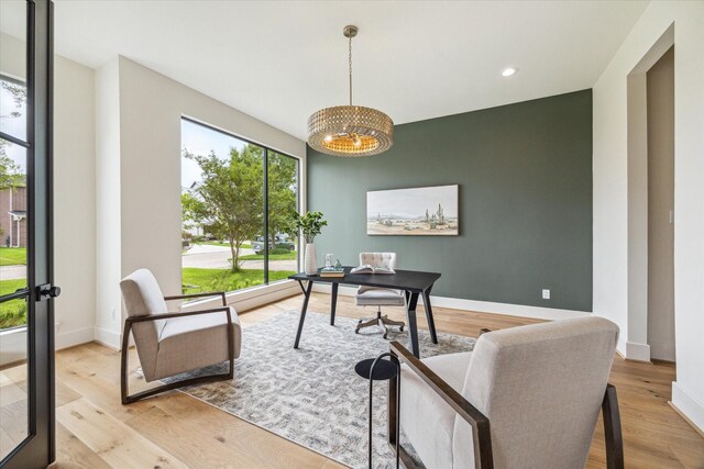 office featuring recessed lighting, baseboards, an inviting chandelier, and wood finished floors