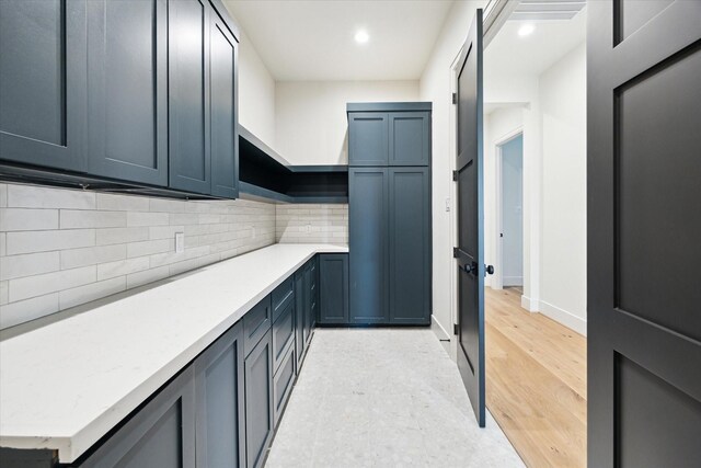 interior space with baseboards, light wood-type flooring, and recessed lighting