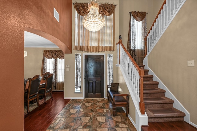 5542 Morgan Park Ln, Sugar Land, TX 77479 - entryway featuring a high ceiling, a notable chandelier, arched walkways, stairs, and visible vents
