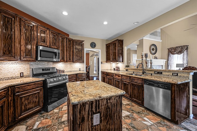 5542 Morgan Park Ln, Sugar Land, TX 77479 - kitchen featuring a sink, stone tile floors, light stone countertops, and stainless steel appliances