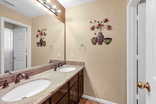 5542 Morgan Park Ln, Sugar Land, TX 77479 - full bath featuring a sink, baseboards, double vanity, and visible vents
