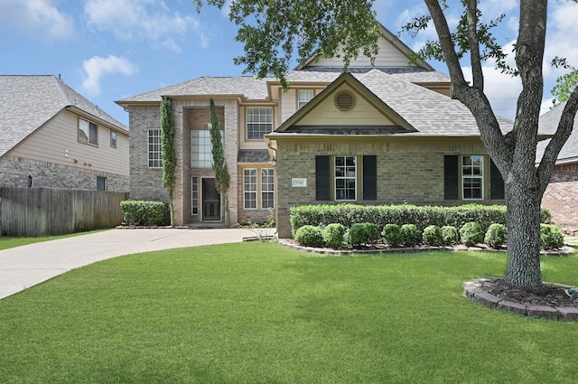 5542 Morgan Park Ln, Sugar Land, TX 77479 - view of front of property featuring driveway, a front yard, brick siding, fence, and a shingled roof