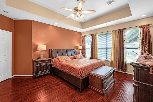 5542 Morgan Park Ln, Sugar Land, TX 77479 - bedroom with wood-type flooring, visible vents, multiple windows, and a raised ceiling