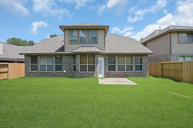 5542 Morgan Park Ln, Sugar Land, TX 77479 - rear view of property with a lawn, brick siding, a fenced backyard, and a patio area