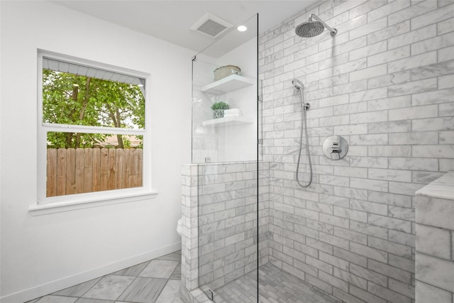 bathroom featuring baseboards, visible vents, a tile shower, and marble finish floor