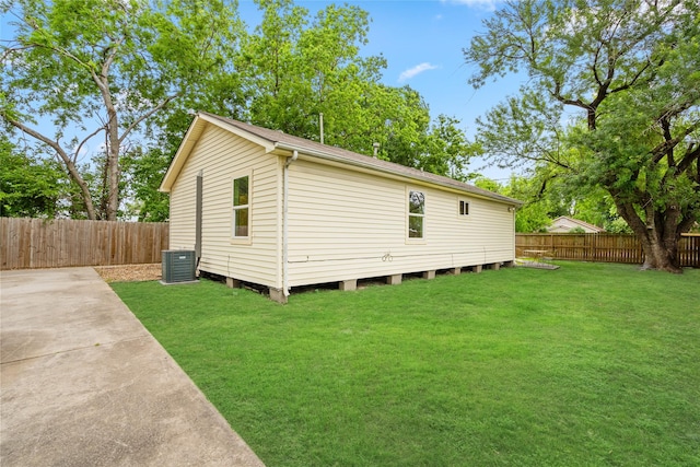 view of property exterior with a yard, a patio, cooling unit, and a fenced backyard