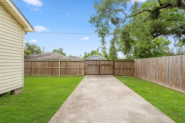 view of yard featuring a fenced backyard, a gate, and a patio